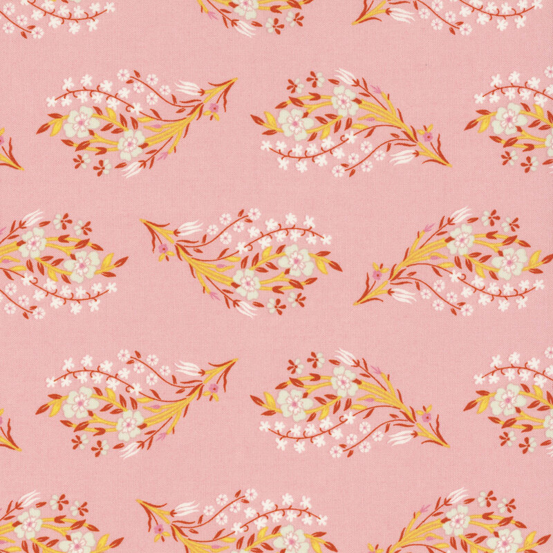 Posies of white flowers with russet and yellow  leaves and stems tossed on salmon pink fabric.