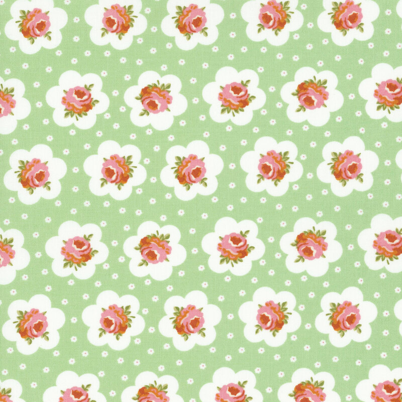 Mint green fabric featuring peach-pink roses outlined in a white flower and small white flowers dotting the background.