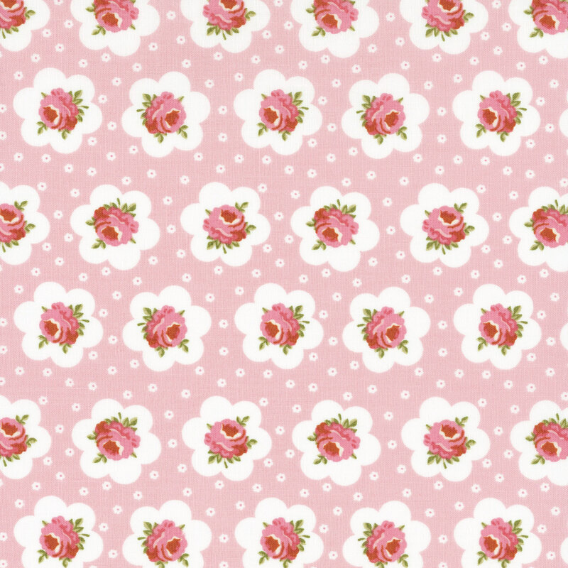 Pink fabric featuring peach-pink roses outlined in a white flower and small white flowers dotting the background.