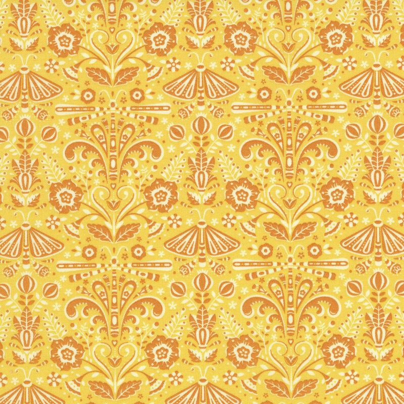 Sunshine yellow fabric featuring peach symmetrical ornamental designs.