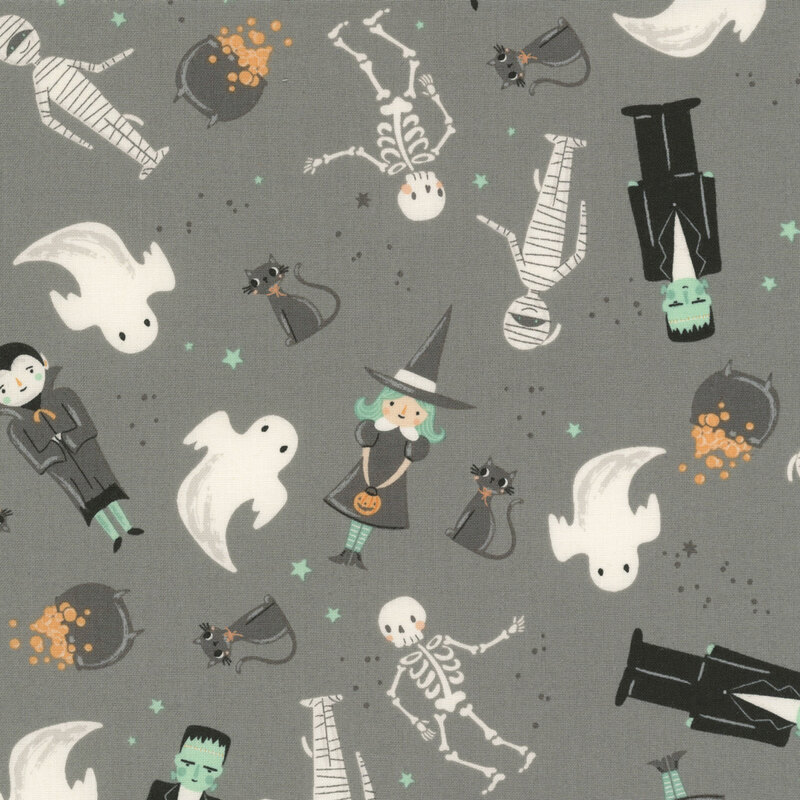 This gray fabric features tossed whimsical Halloween characters, including ghosts, witches, skeletons, black cats, mummies, and Frankenstein.