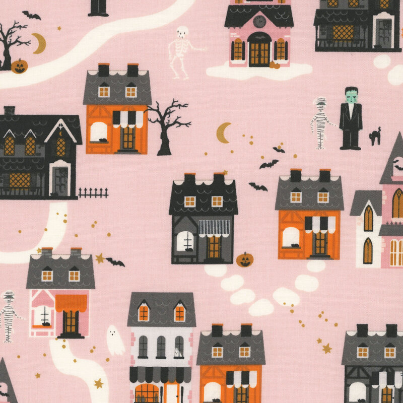 This light pink fabric features a whimsical Halloween village with spooky houses, ghosts, bats, pumpkins, and classic monster characters.