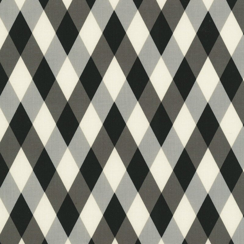 This black, gray, and white geometric print features an harlequin diamond pattern. 
