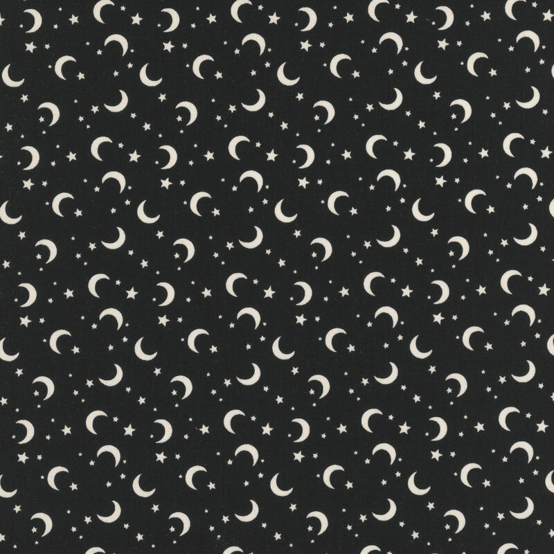 This black fabric features scattered glow in the dark crescent moons and stars.