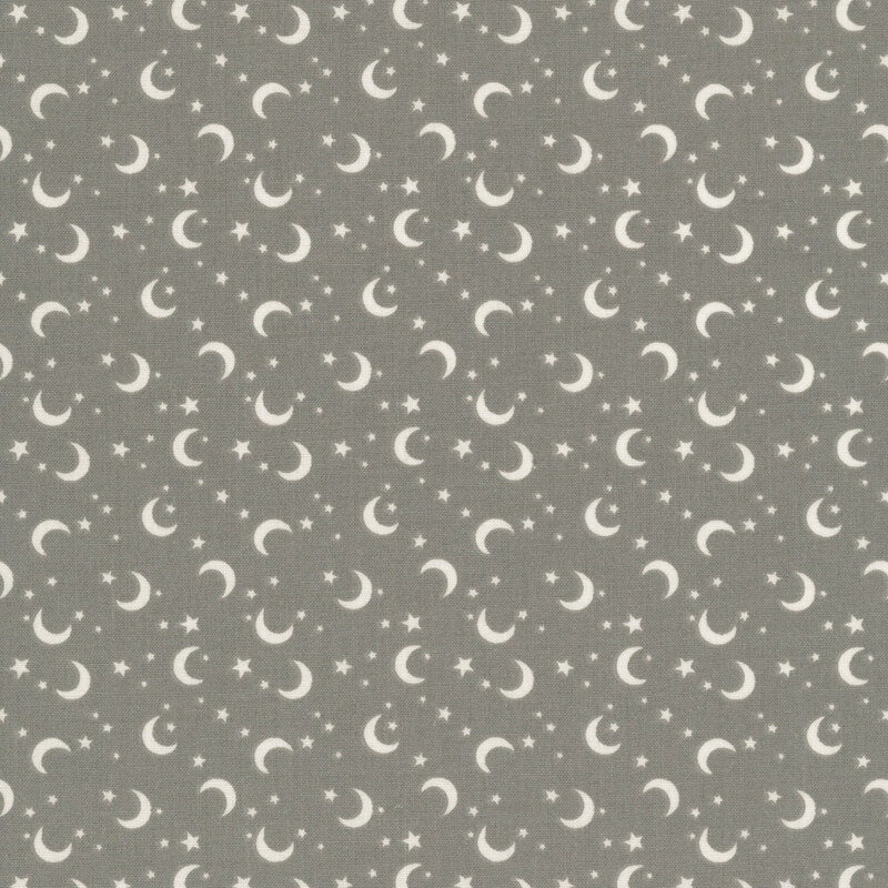 This gray fabric features scattered crescent moons and stars.