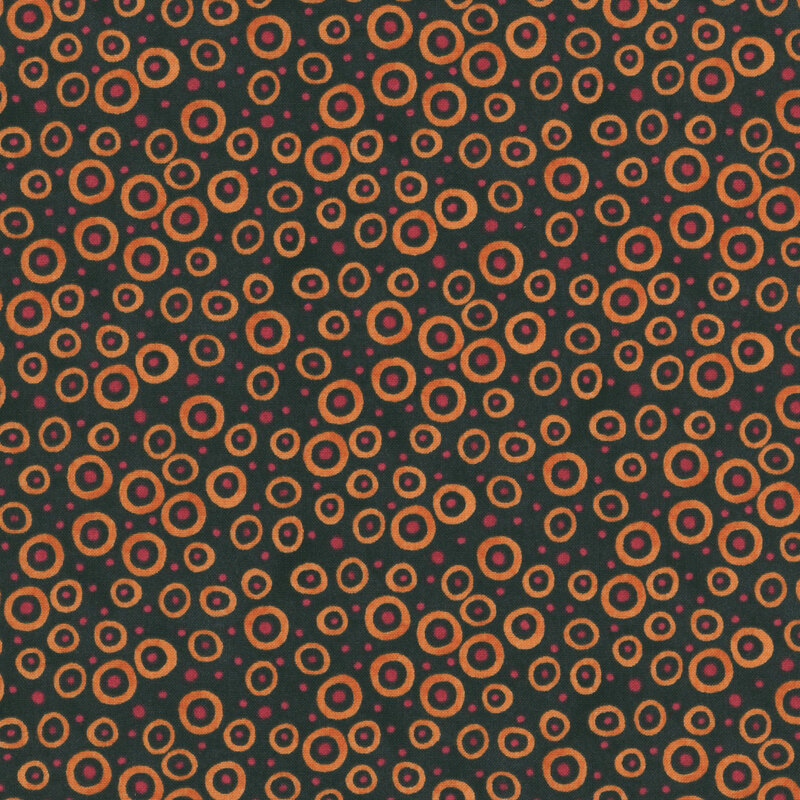 black fabric scattered with orange dots and circles in various sizes.