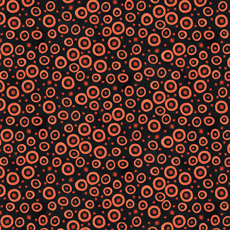 black fabric scattered with orange dots and circles in various sizes.