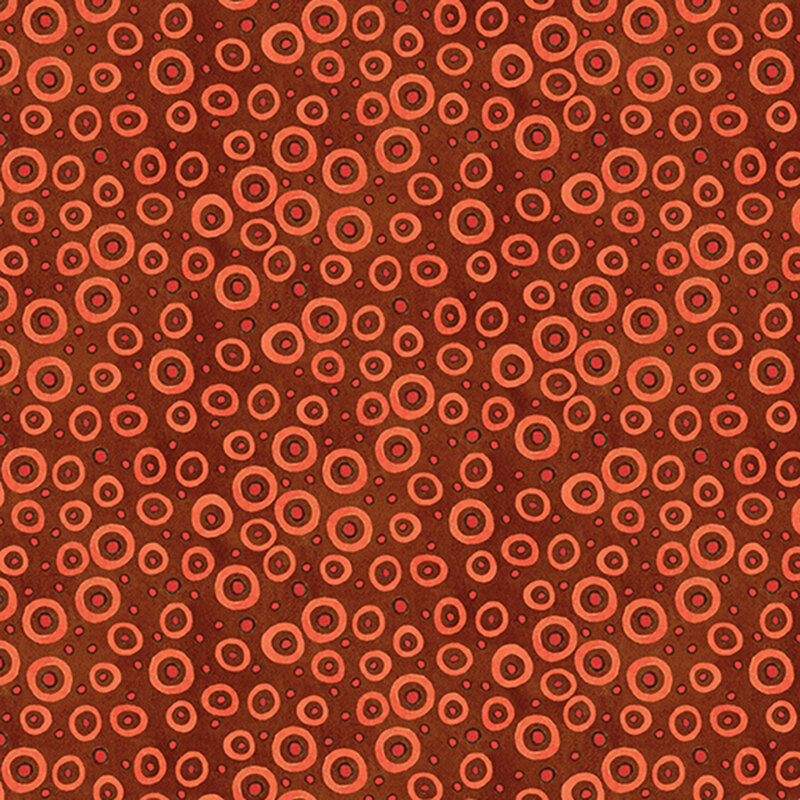 mottled rustic red fabric scattered with orange dots with black outlines and circles in various sizes.