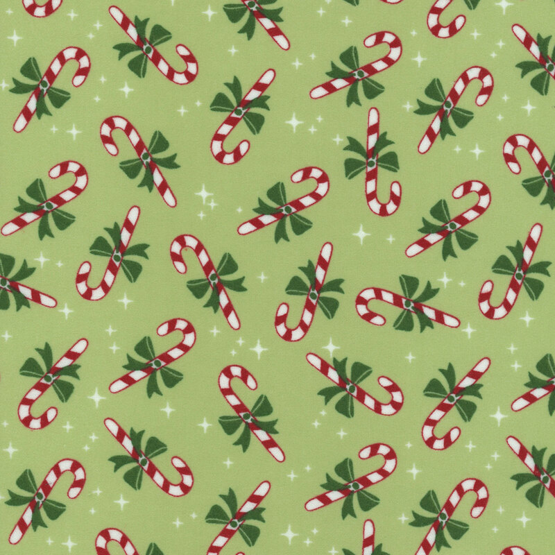 A light green fabric with tossed candy canes and white sparkles.  