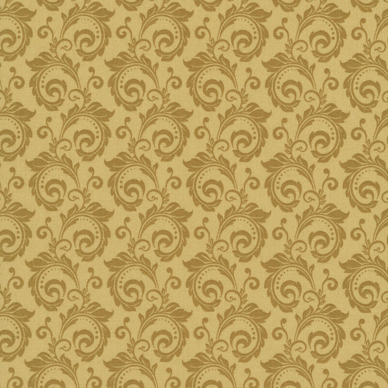 tonal golden fabric featuring a swirl pattern.