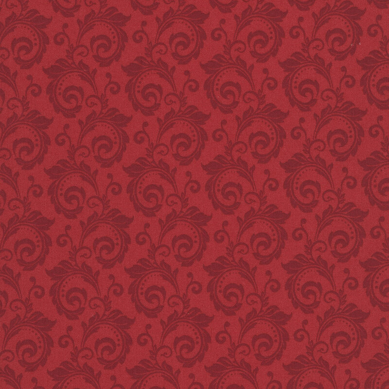 Tonal red fabric featuring a swirl pattern.