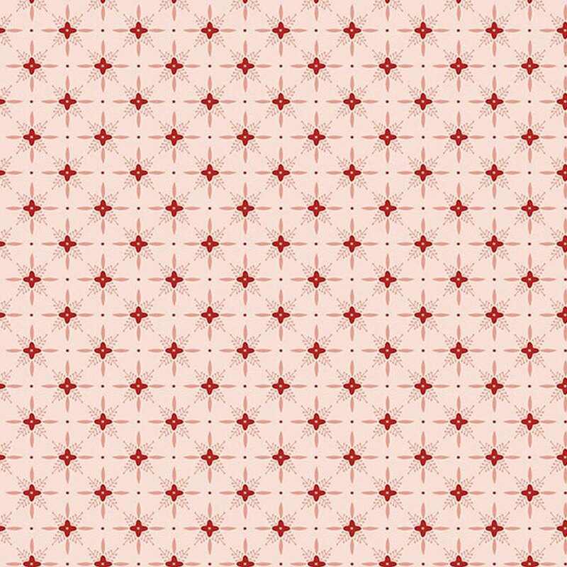 Pink fabric with a red pattern of geometric shapes in a lattice with florals. 