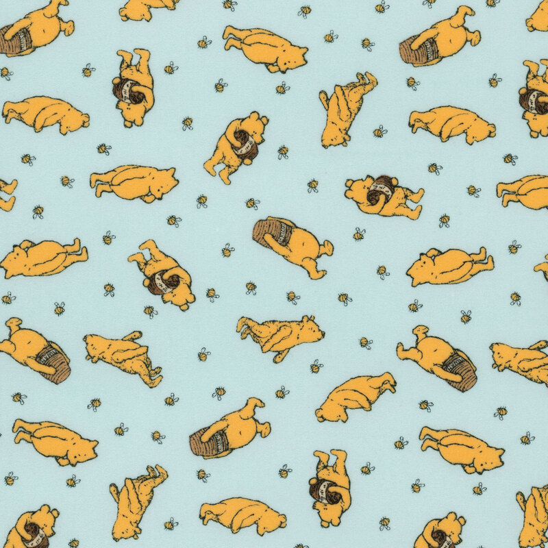 pale aqua flannel fabric tossed with Winnie the Pooh with a jar of honey surrounded by bees.