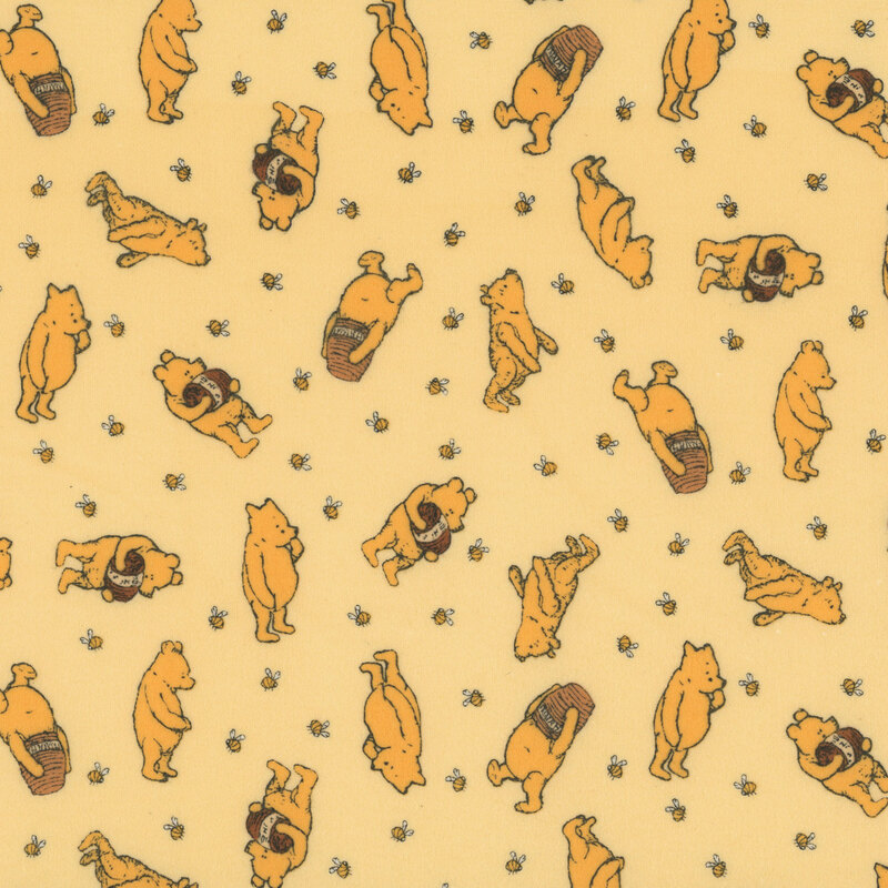 pale yellow flannel fabric tossed with Winnie the Pooh with a jar of honey surrounded by bees.