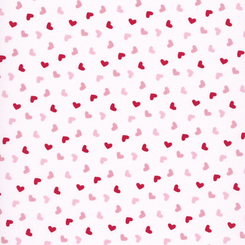 white fabric with a pattern of red and pink hearts