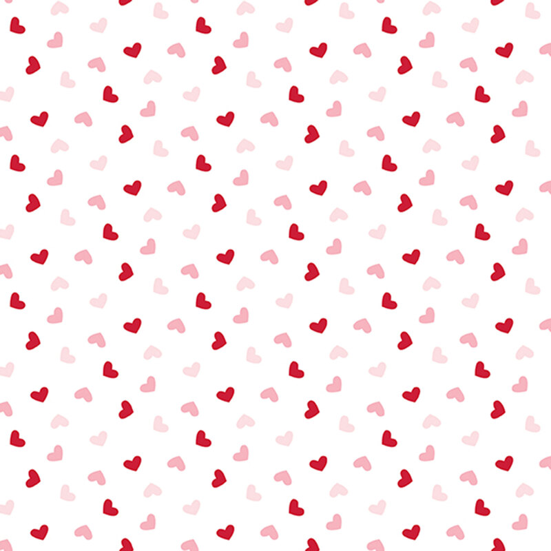 white fabric with a ditsy pattern of red and pink hearts