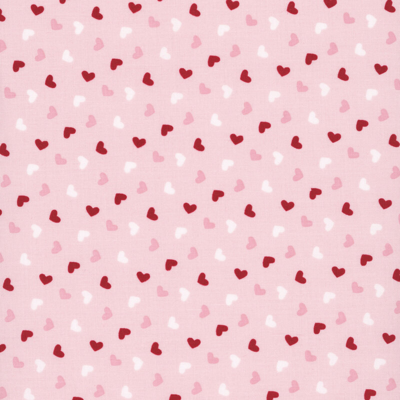 light pink fabric with a pattern of red, pink, and white hearts