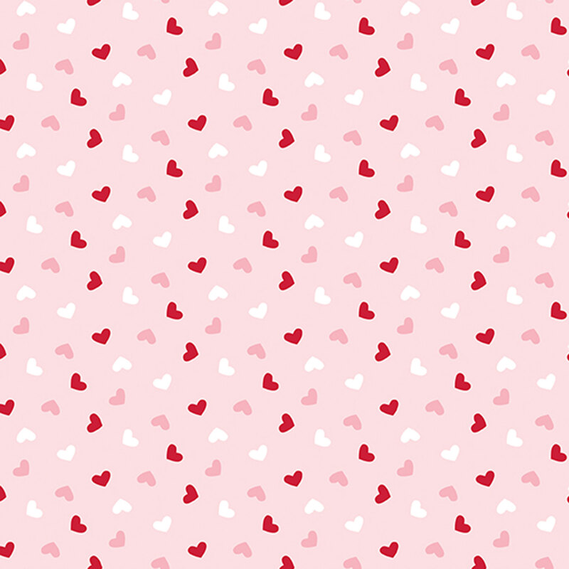 light pink fabric with a ditsy pattern of red, pink, and white hearts