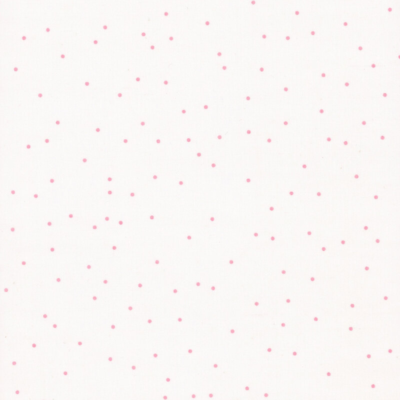 small pink dots tossed on white fabric