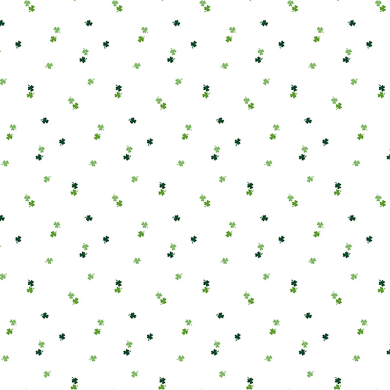dark and light green shamrocks tossed on a white fabric
