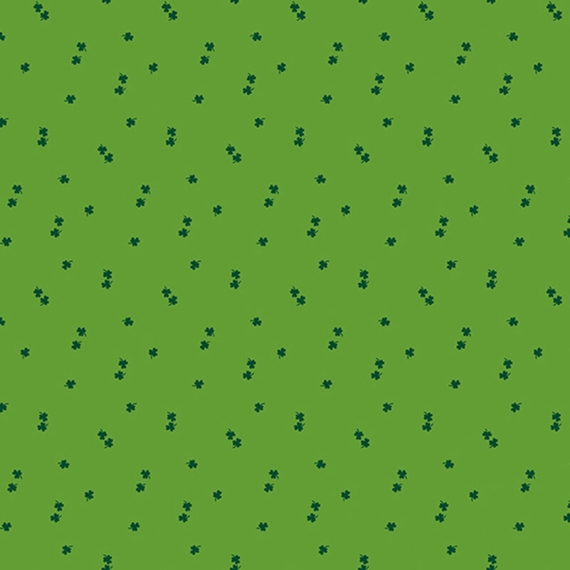dark green shamrocks tossed on a grass green fabric