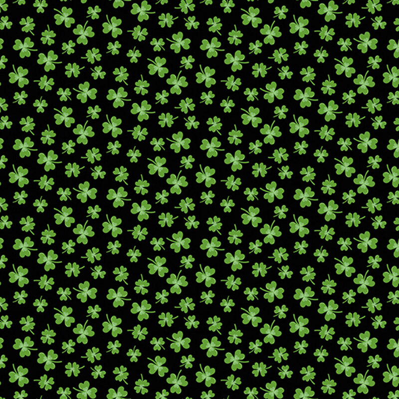green clovers in various sizes scattered on jet black fabric