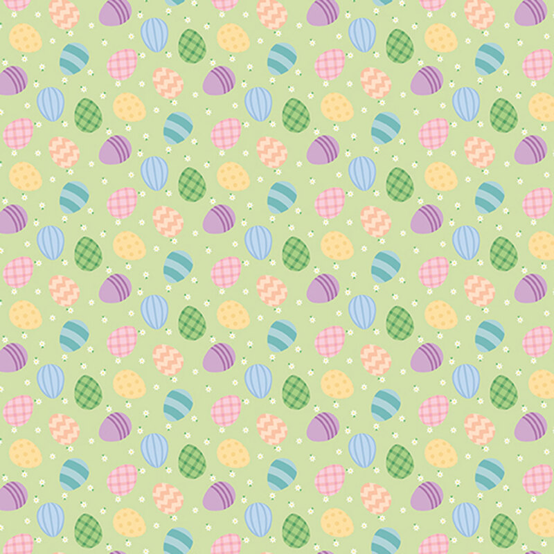 colorful easter eggs and white daisies scattered on pastel green fabric