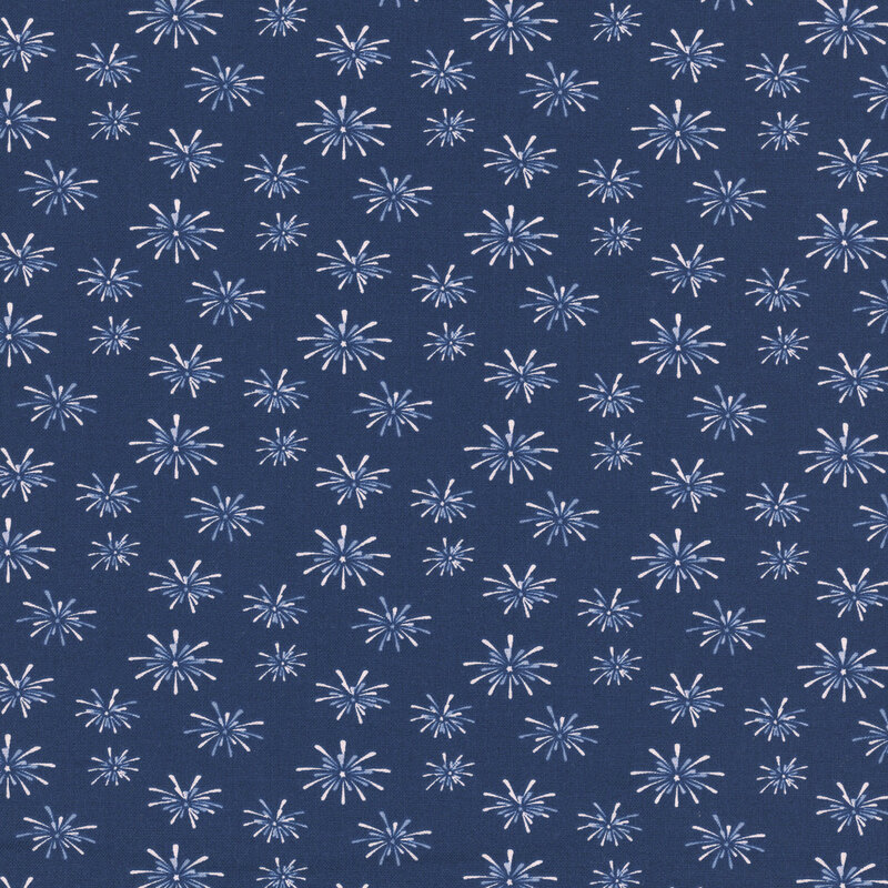 denim blue fabric tossed with bursts of white fireworks