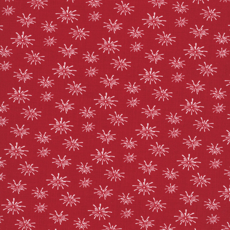cherry red fabric tossed with bursts of white fireworks