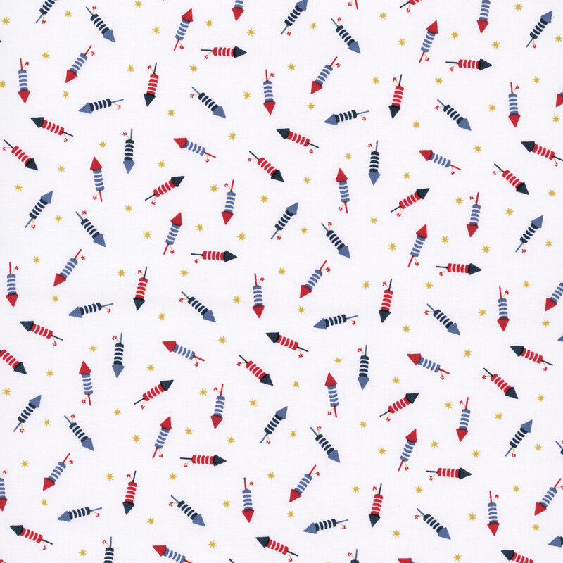snow white fabric tossed with bottle rockets in red, white and blue amongst yellow stars
