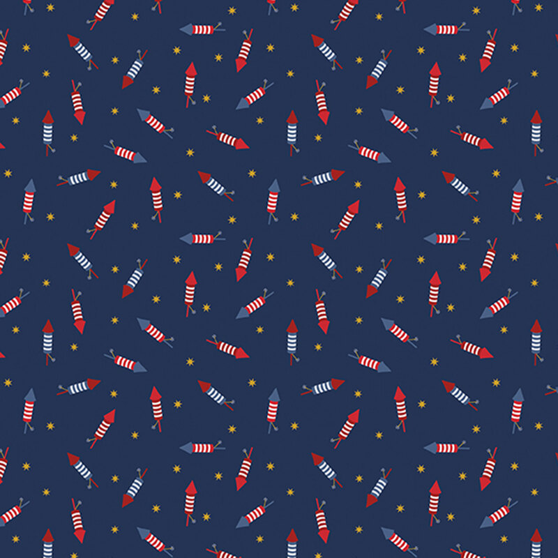 navy blue fabric tossed with bottle rockets in red, white and blue amongst yellow stars