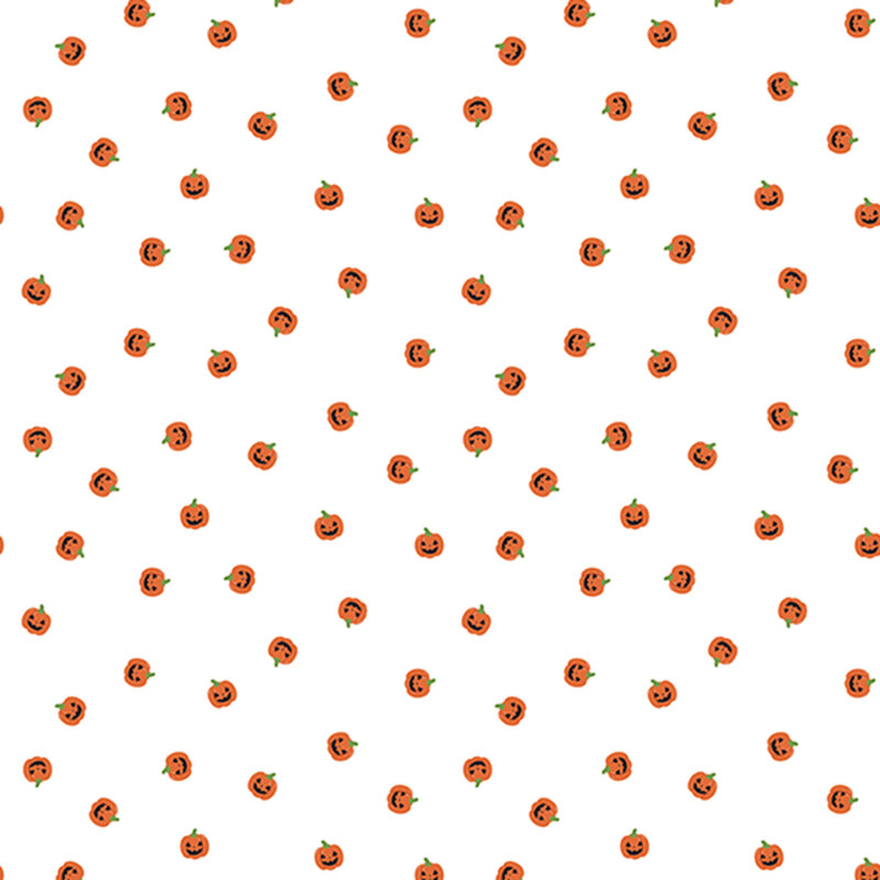 orange carved pumpkin heads scattered on white fabric