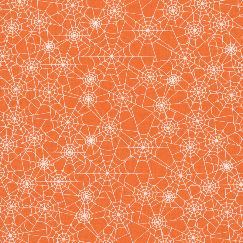 pumpkin orange fabric covered in white spider webs