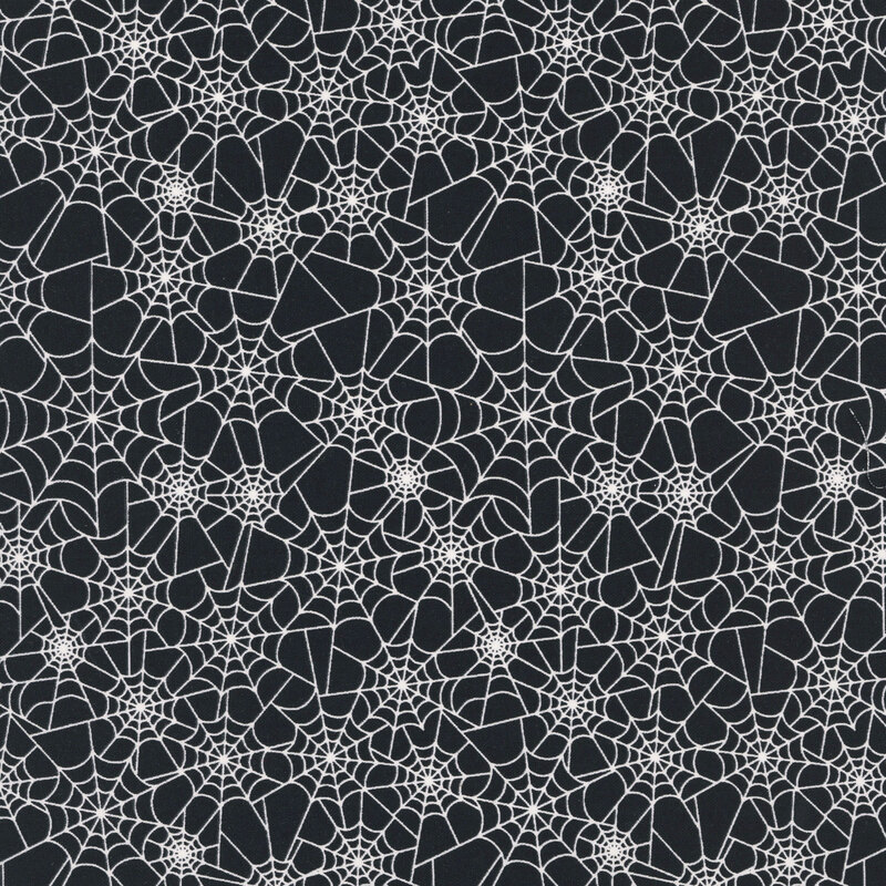 Black fabric covered in glow in the dark white spider webs