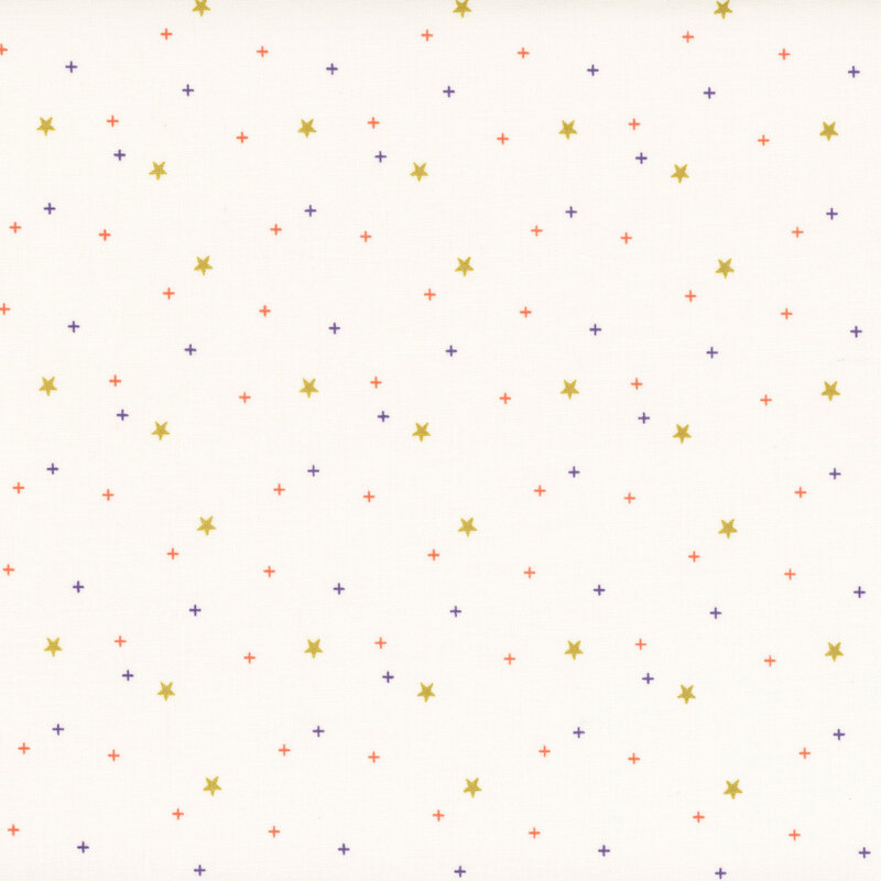 gold stars scattered with purple and orange crosses on light cream fabric