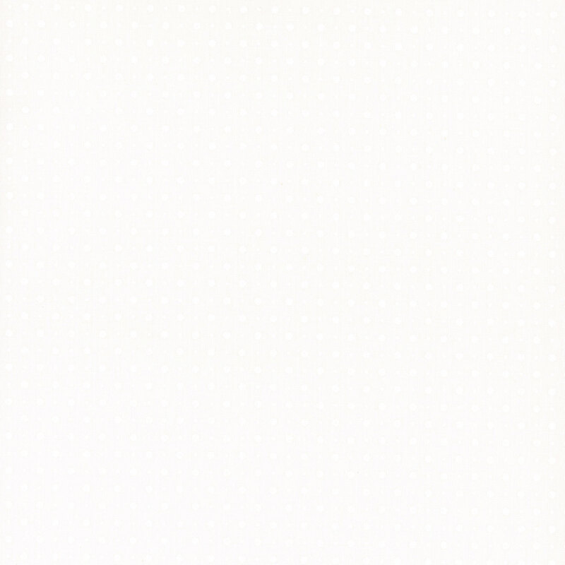 White fabric with a pattern of small and tiny tonal polka dots.