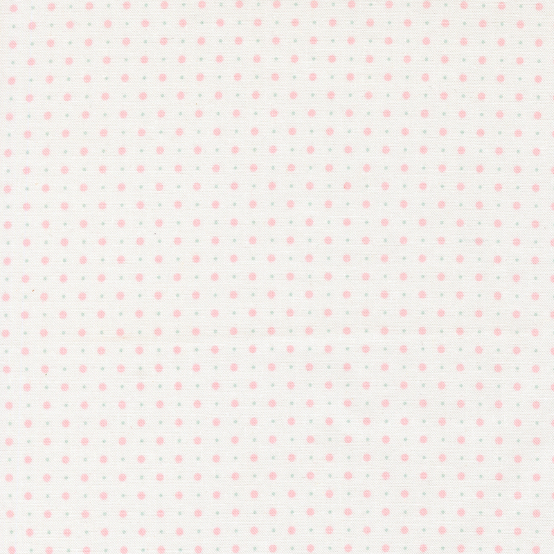 White fabric with a pattern of small and tiny polka dots.