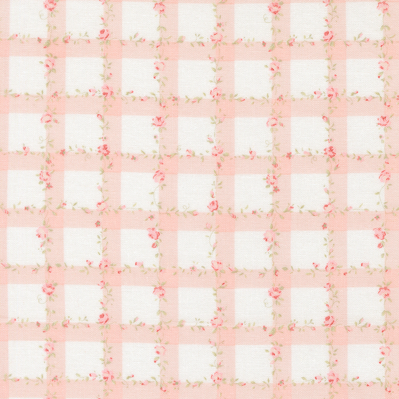 White fabric with a pink gingham pattern scattered with pink roses and green leaves.
