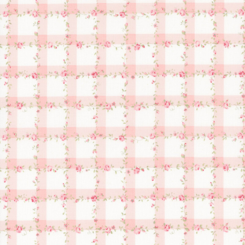 White fabric with a pink gingham pattern scattered with pink roses and green leaves.