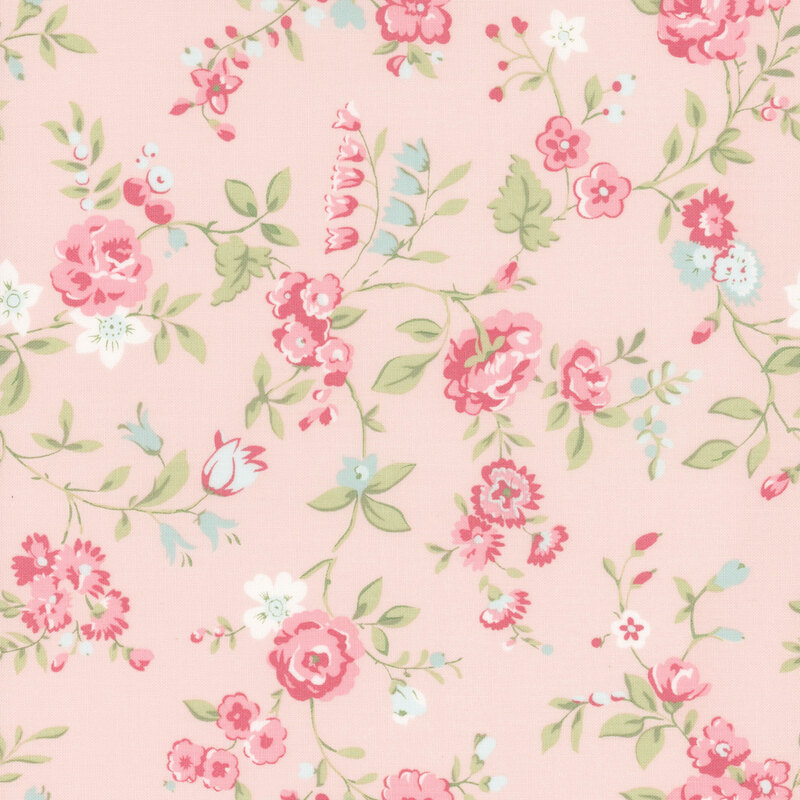 Pink fabric with a pattern of large salmon and blue florals alongside green leaves.