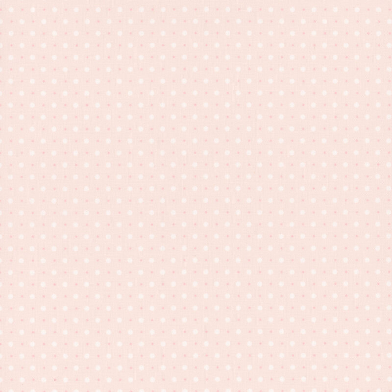 pink fabric with a pattern of small and tiny white polka dots.