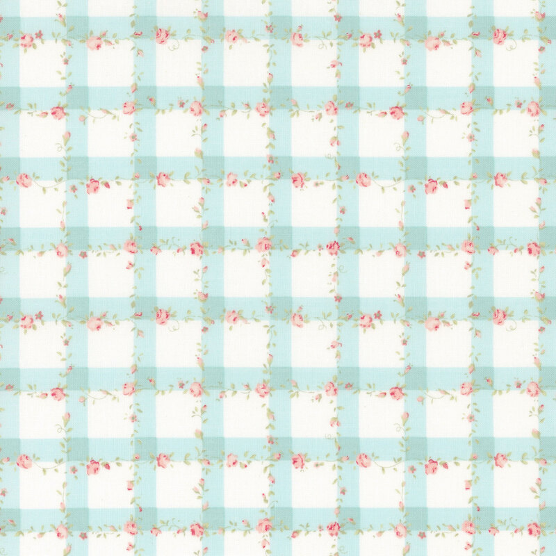 White fabric with a light blue gingham pattern scattered with pink roses and green leaves.
