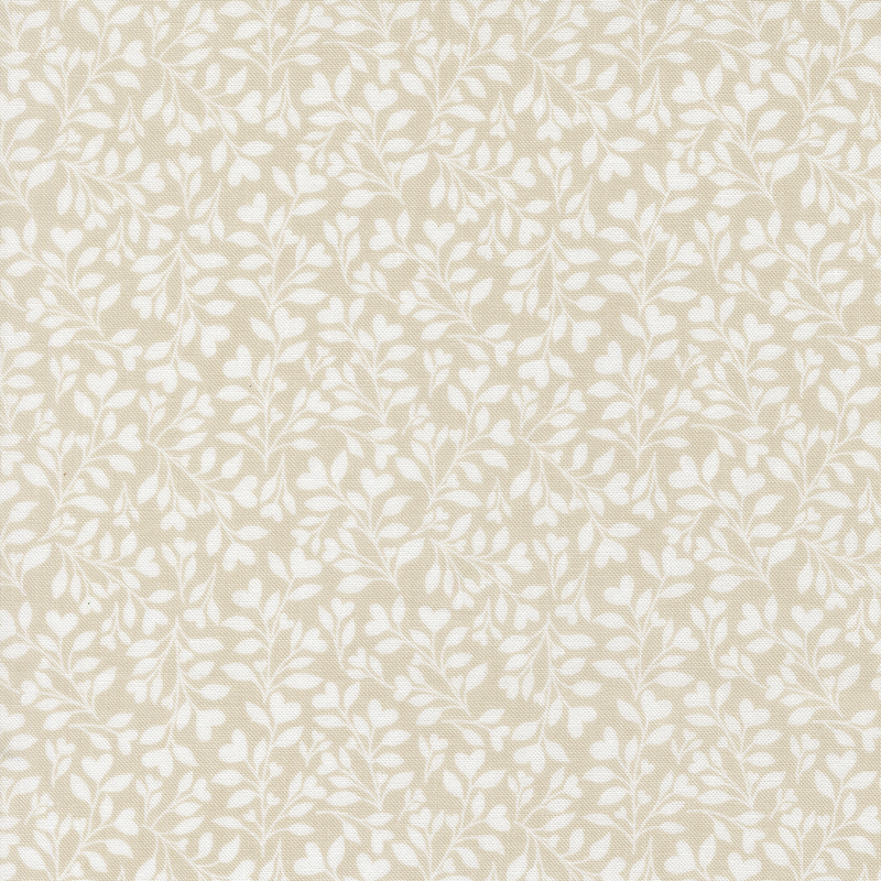 Beige fabric with a dense pattern of white leaves and vines accented with subtle hearts.