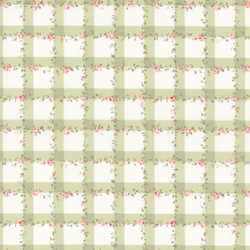 white fabric with a green gingham pattern scattered with pink roses and green leaves.