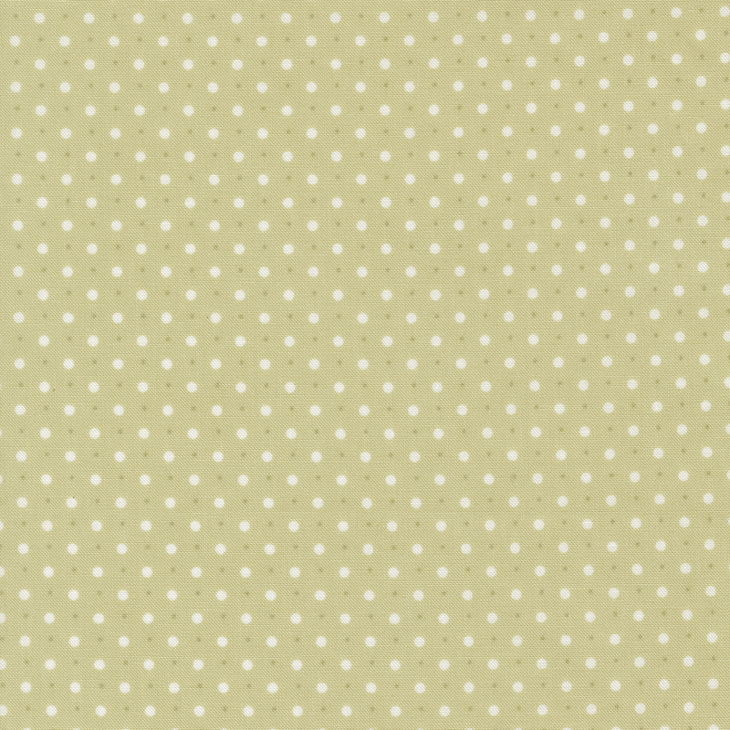 Green fabric with a pattern of small and tiny white polka dots.