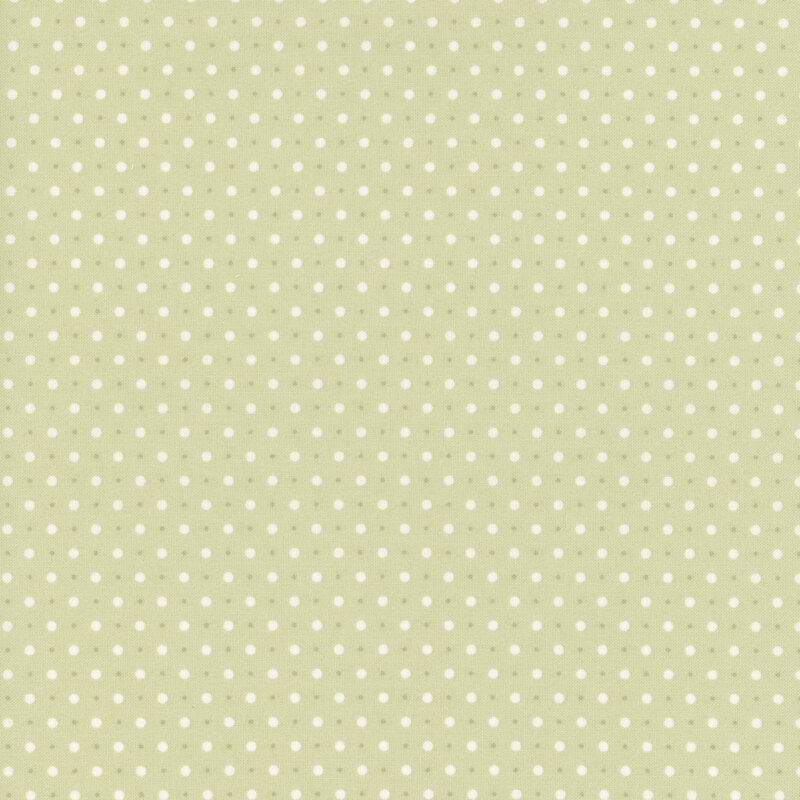 Green fabric with a pattern of small white and tiny beige polka dots.