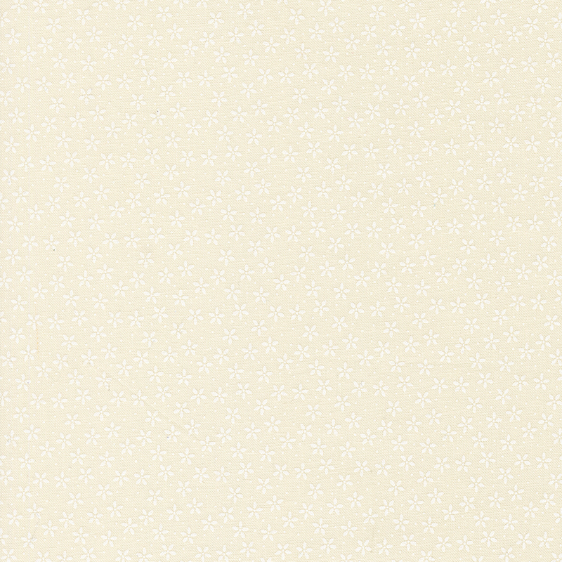 Ivory fabric with tiny white flowers crowded together amongst pinprick dots.