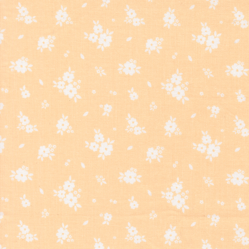Bright peach fabric with tossed clusters of white flowers.
