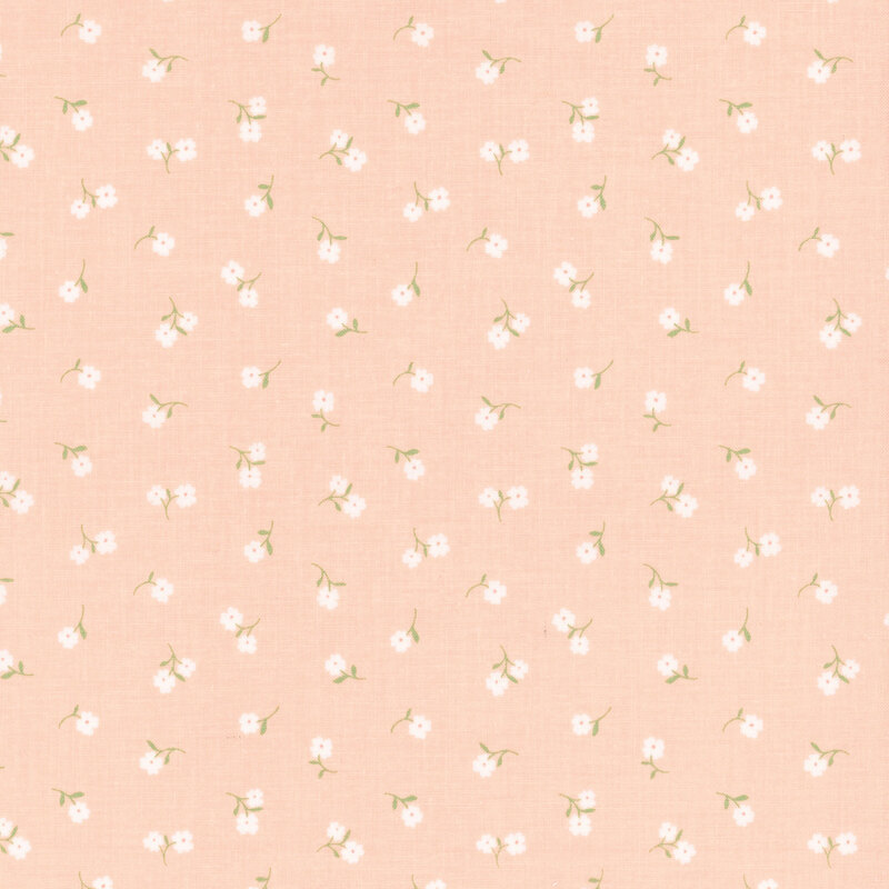 Pastel peach fabric with tossed white flowers.