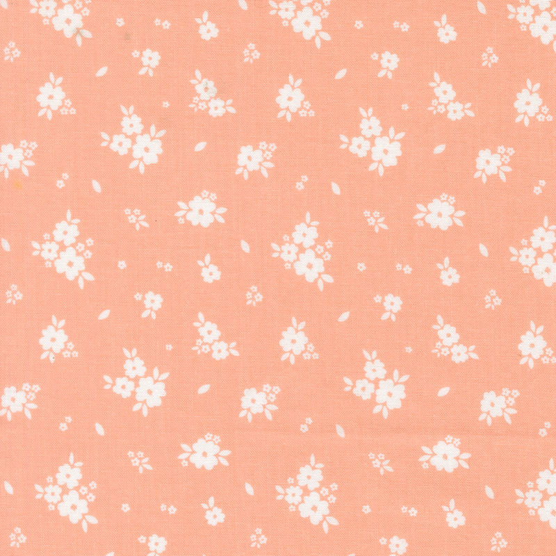 Bright coral fabric with tossed clusters of white flowers.